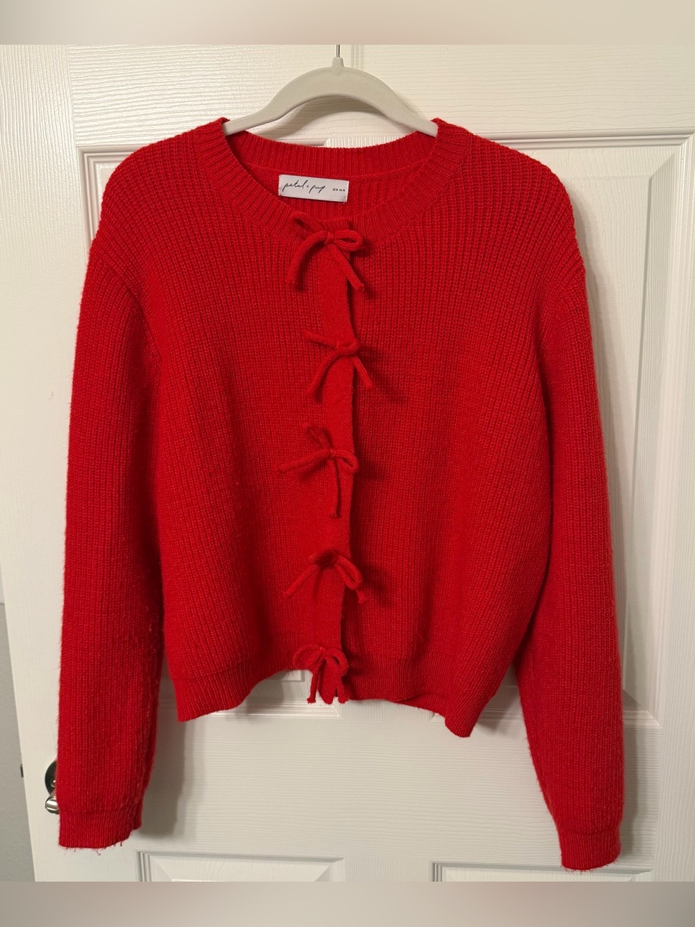Bright red knit cardigan with bows